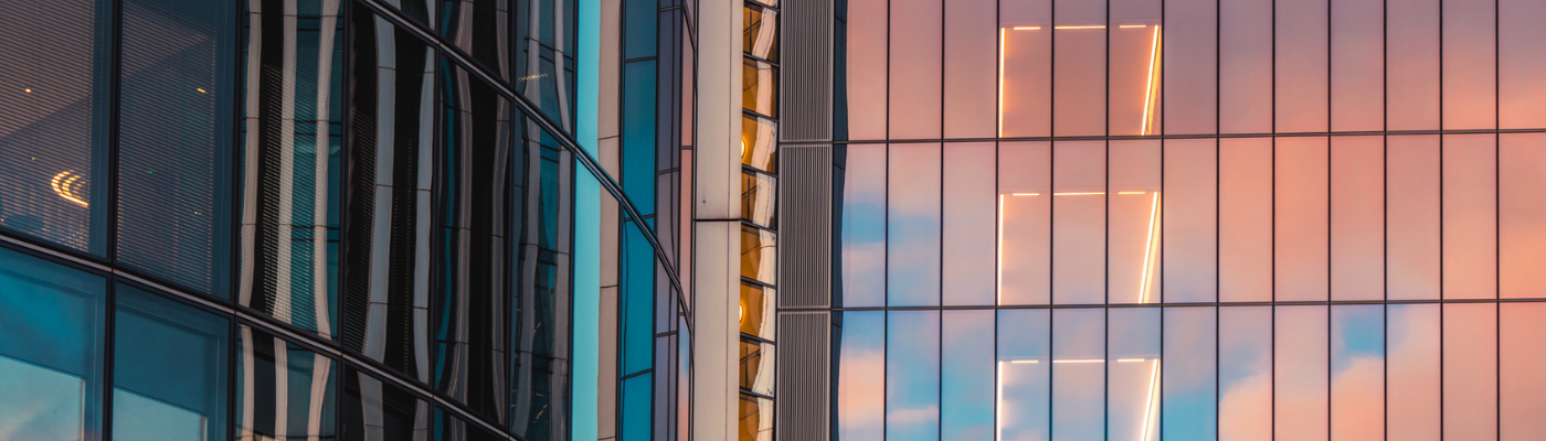 Modern glass skyscrapers reflecting vibrant sunset