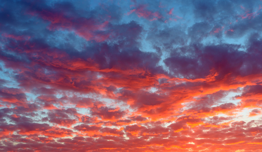 Vibrant sky filled with clouds illuminated by a stunning sunset
